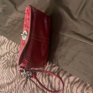 Red patent leather Coach wristlet.
